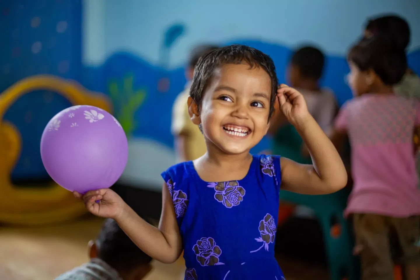 A girl playing with a balloon