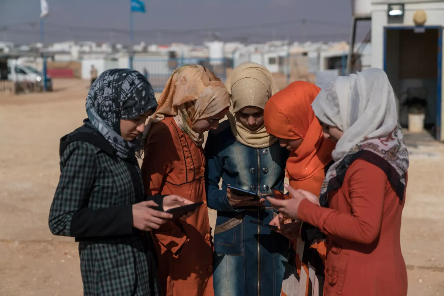 Adolescent girls use cellphones and tablets in the Za&rsquo;atari camp for Syrian refugees, in Mafraq Governorate, near the Syrian border. Open source app Primero launched to help protect children displaced by conflict.
