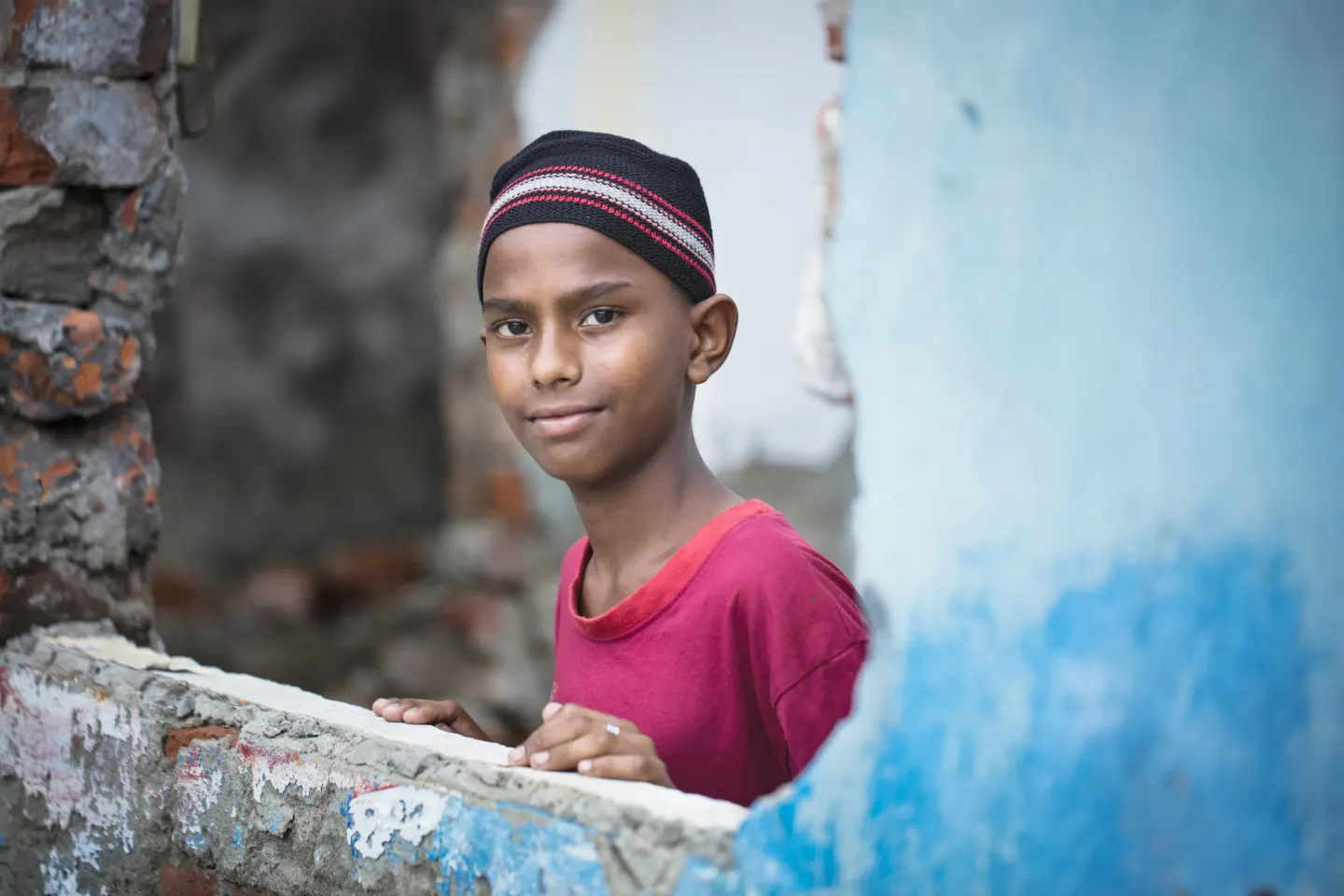 Imran (11). &nbsp;WASA Colony, Sayedabad, Dhaka. 30 May 2021.&nbsp;Eleven-year-old Imran Hossain works at a paper recycling shop in Dhaka making paper bags. Imran lives with his parents and two younger brothers in a house in the densely packed Wasa Colony (urban slum) in Sayedabad, Dhaka. Their one room shelter is made of corrugated metal. The home consists of one bed, a storage rack, a table and an old TV. The Wasa Colony is home to one thousand families, often living in challenging, unsanitary conditions.