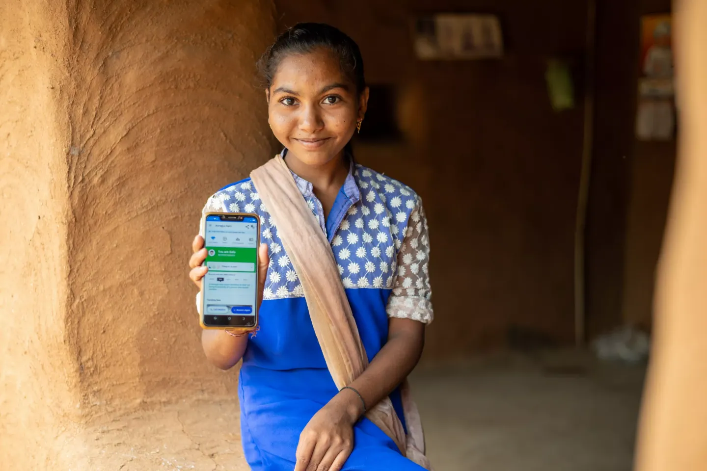 Sanajan Gamar (14) demostrates use of aarogya setu app and masks during COVID 19. Unicef  partners with Narottam Lalbhai Rural Development Fund for Parivartan program  wihich focusses on transofrming lives throught complementary feeding  and hygiene practices.  Location : Kanthapura , Khedbrahma, Sabarkantha, Gujarat, India