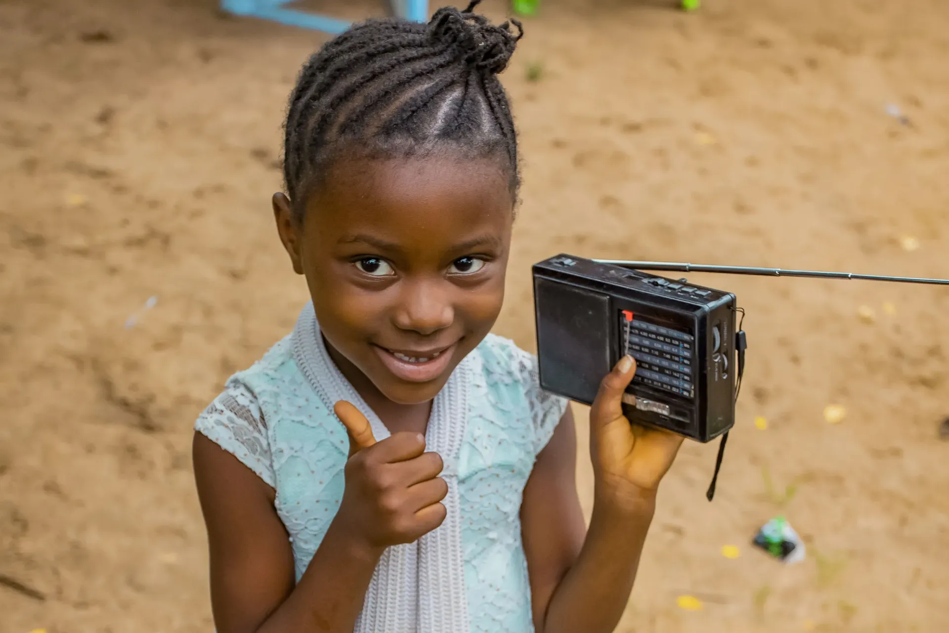 Kikwit, Kwilu province. Abiga&euml;l, 8 years old, listens to teachings on the radio. A Listening Club was set up in her neighborhood when the schools were closed because of the coronavirus. Although the schools have reopened today, the Listening Club continues to gather.