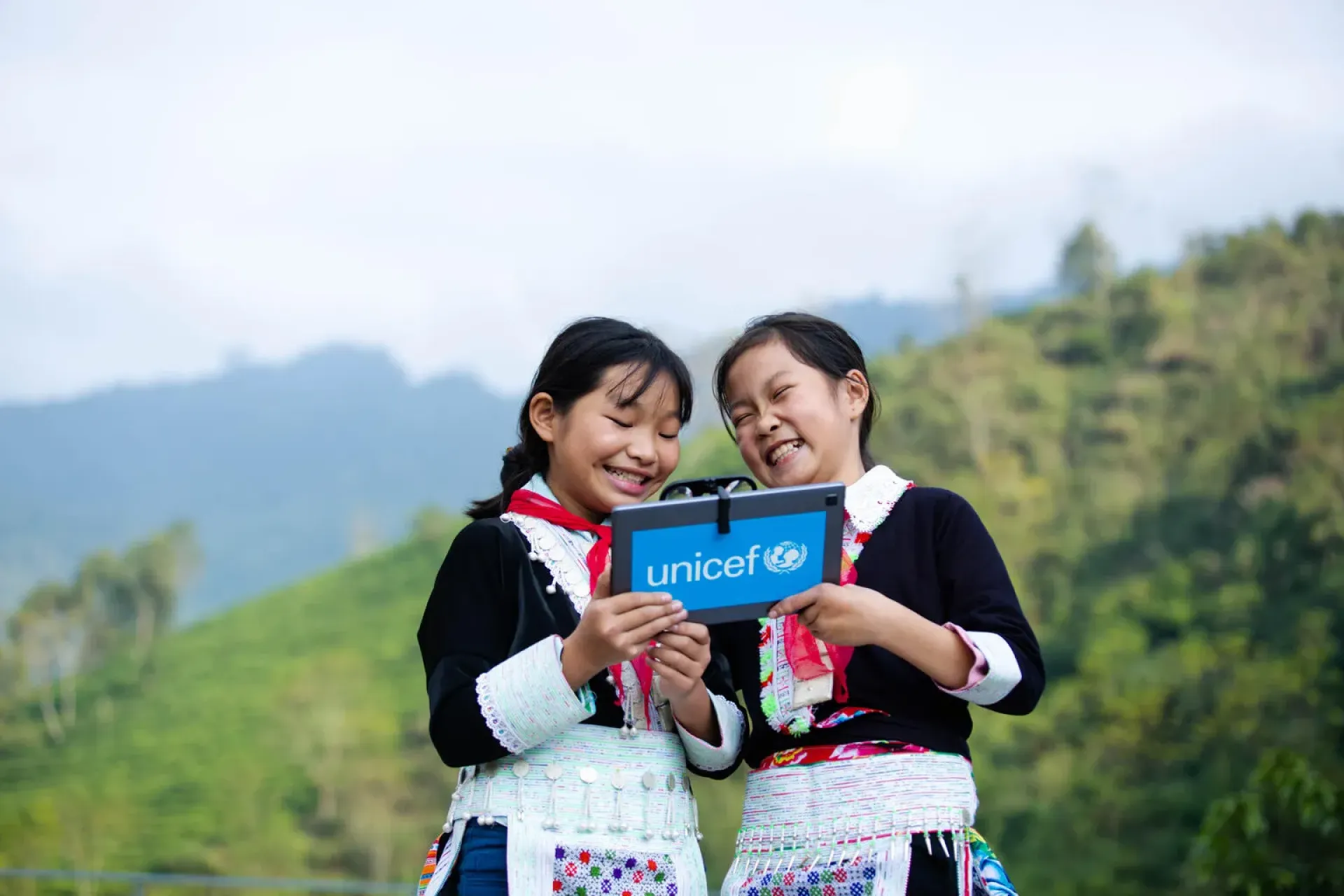 Tan Thanh Hien (left) 11 years old and her friend Tan Thi Hang (right) 11 years old, were trying the AR technology on the tablet supported by UNICEF at Bat Xat secondary high school in Lao Cai.