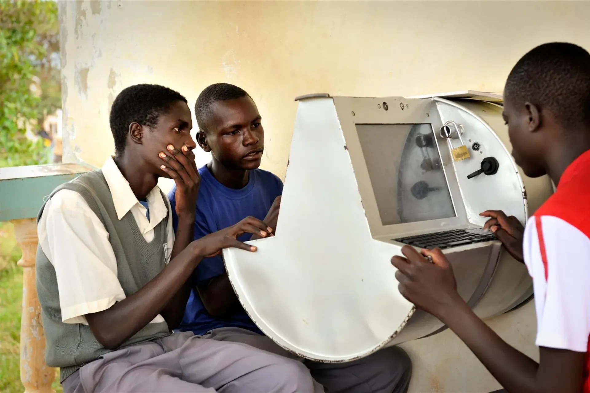 Young Ugandans gather around to use UNICEF&rsquo;s unique innovation the solar-powered Digital Drum, at Bosco Youth Centre in Gulu, Uganda. &nbsp;The Digital Drum was this month chosen as one of Time Magazine&rsquo;s Best Inventions of 2011.