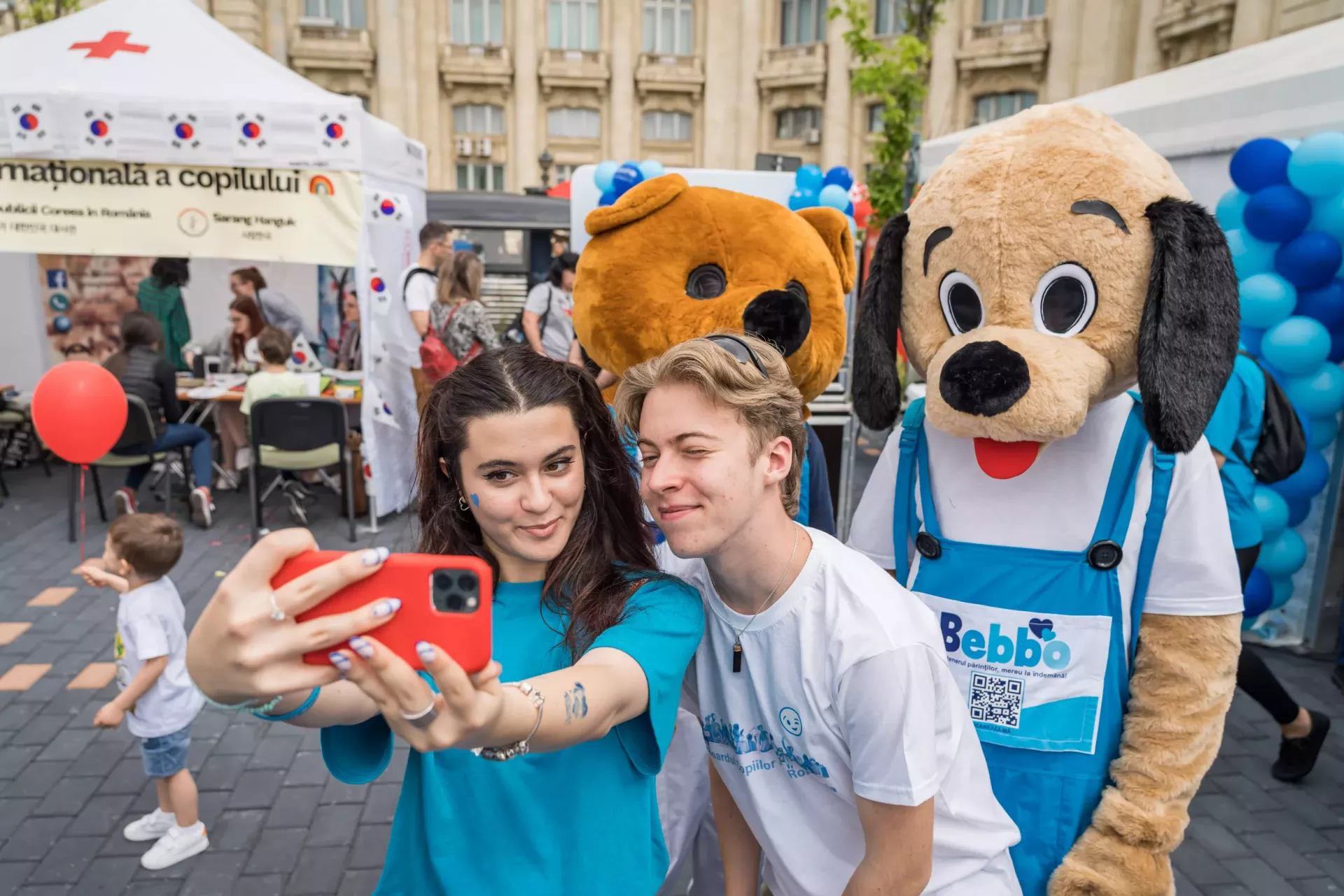 Miruna and Horia, two members of the UNICEF-supported Children's Board, take a selfie with the Bebbo mascott during the 1st of June event 'Children's Senate'.