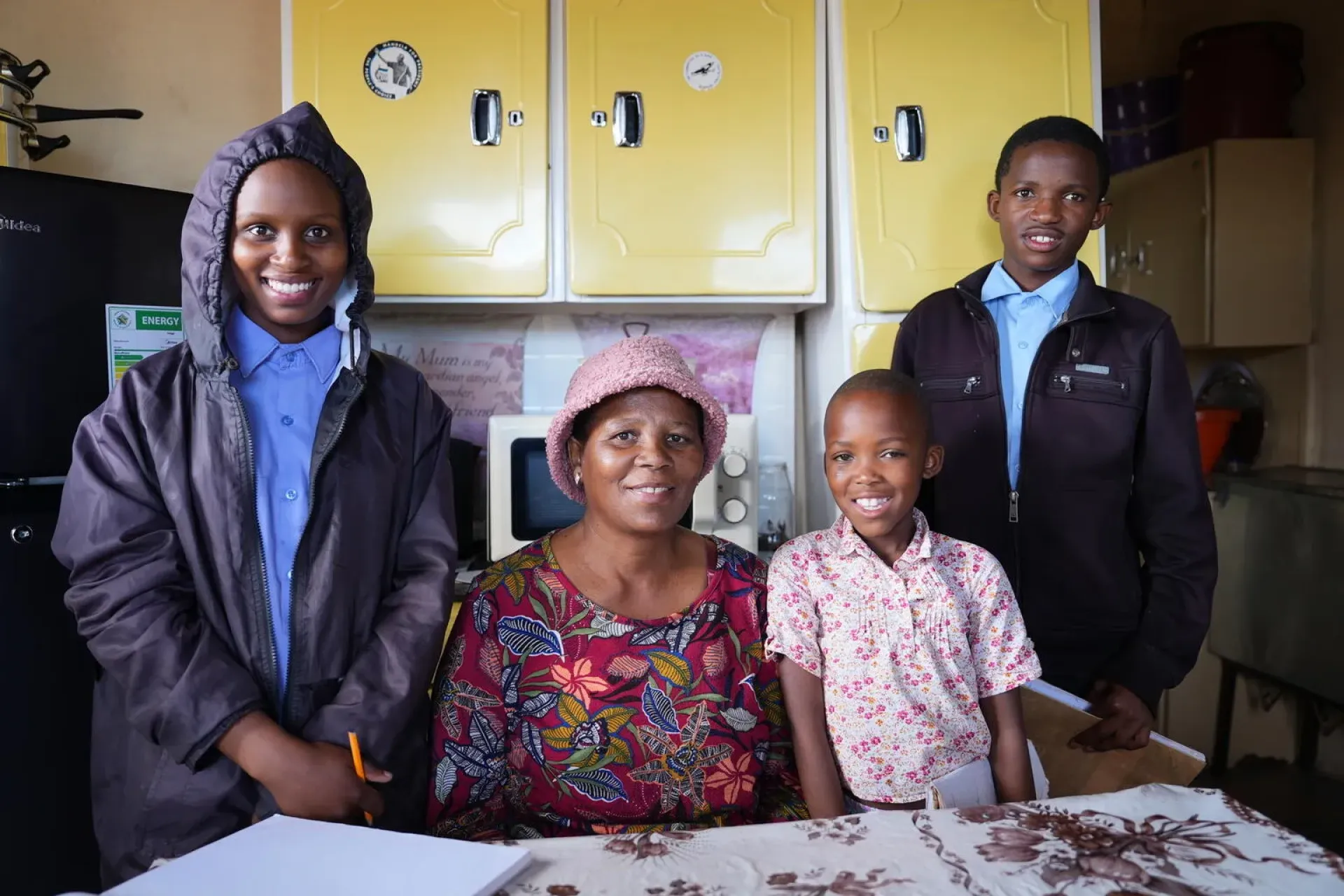 Ma Nkhahle, a recipient of the social security grant in Lesotho, pictured at home with her children.