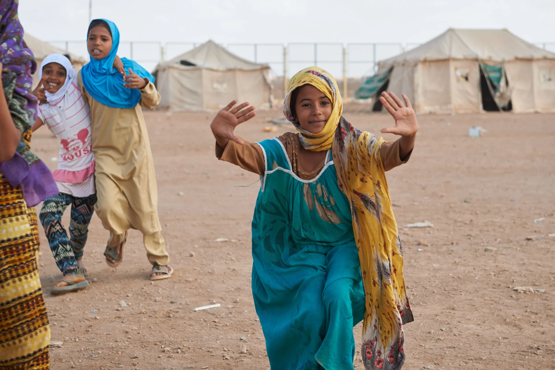 A girl raising her hand in front of the camera