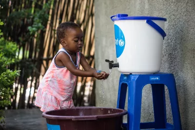 A little girl washes her hands at a UNICEF handwashing station