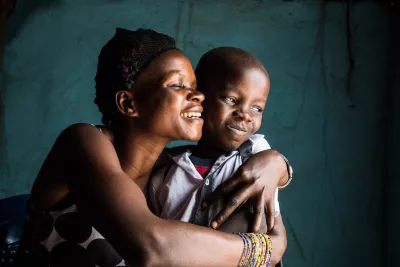 A mother holds her son affectionately
