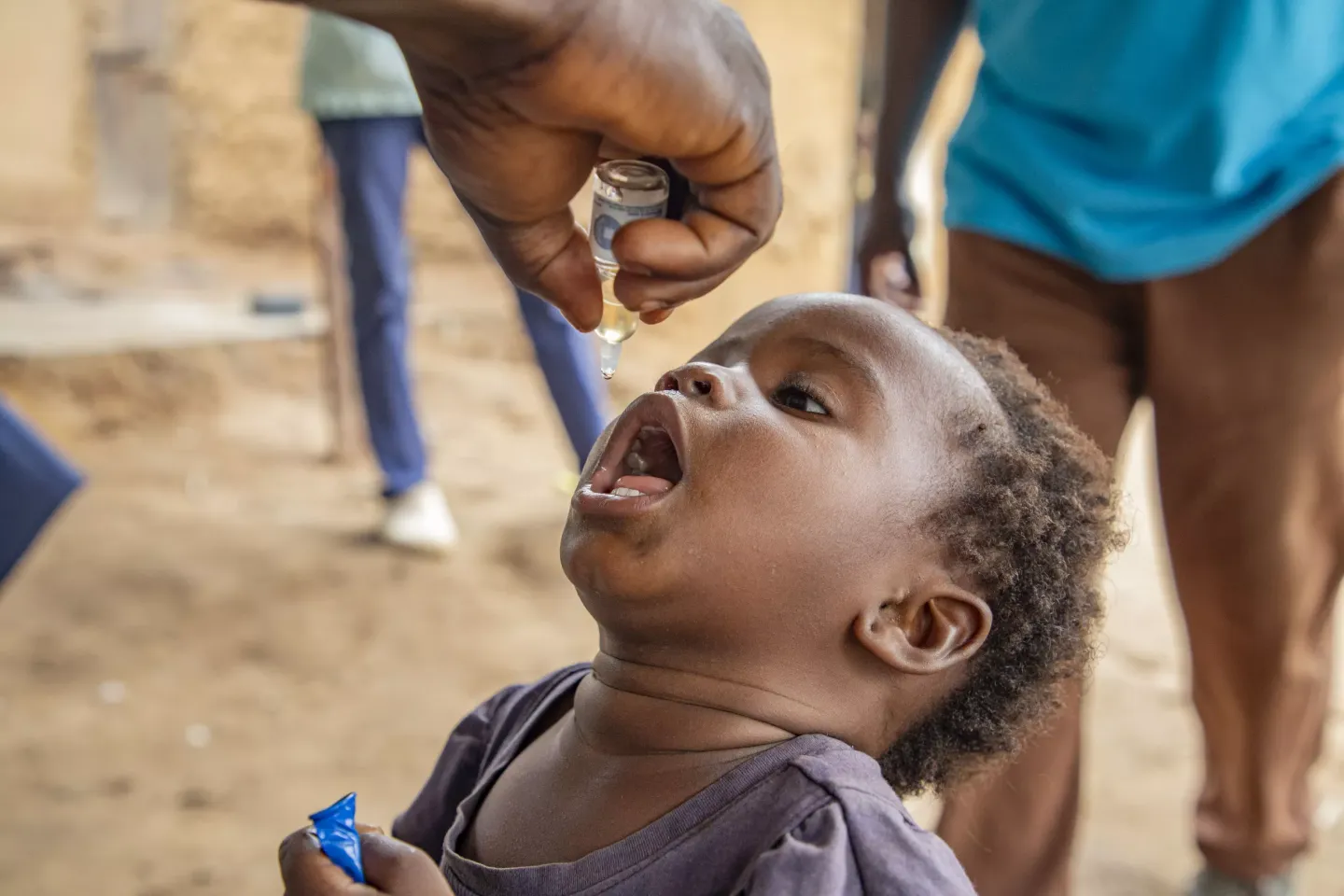 Promedi, 3, receives a polio vaccine in Kikwit. 
