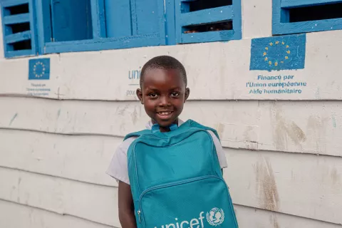 A young girl holds her UNICEF schoolbag