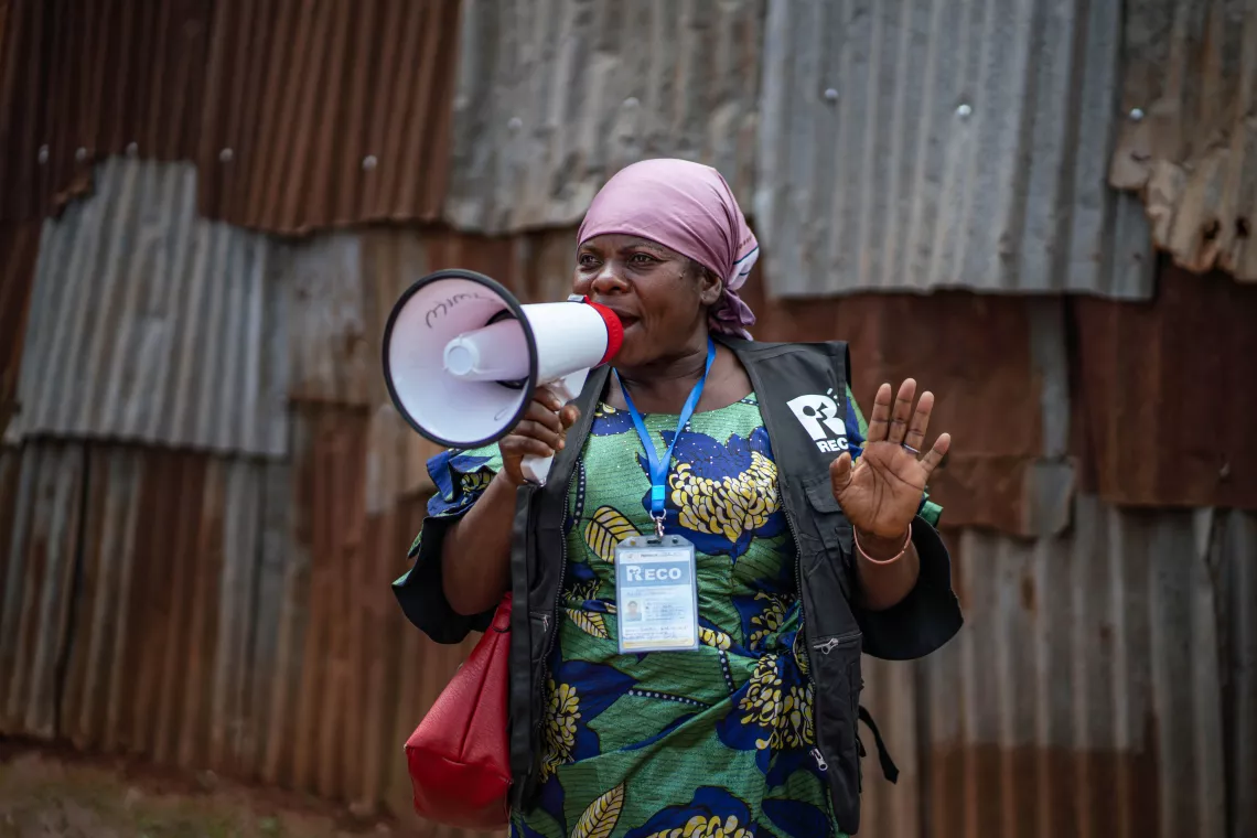 A woman speaking into a megaphone.
