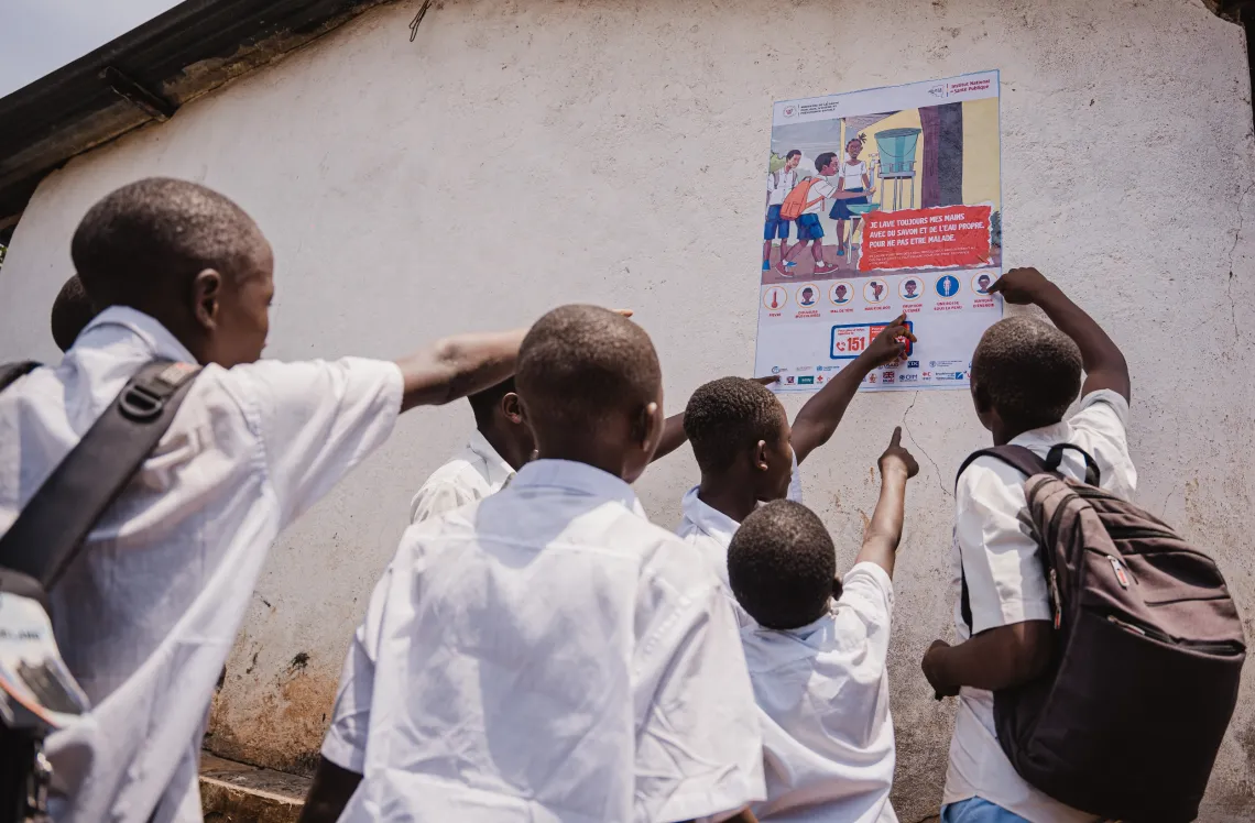 Students look at a poster