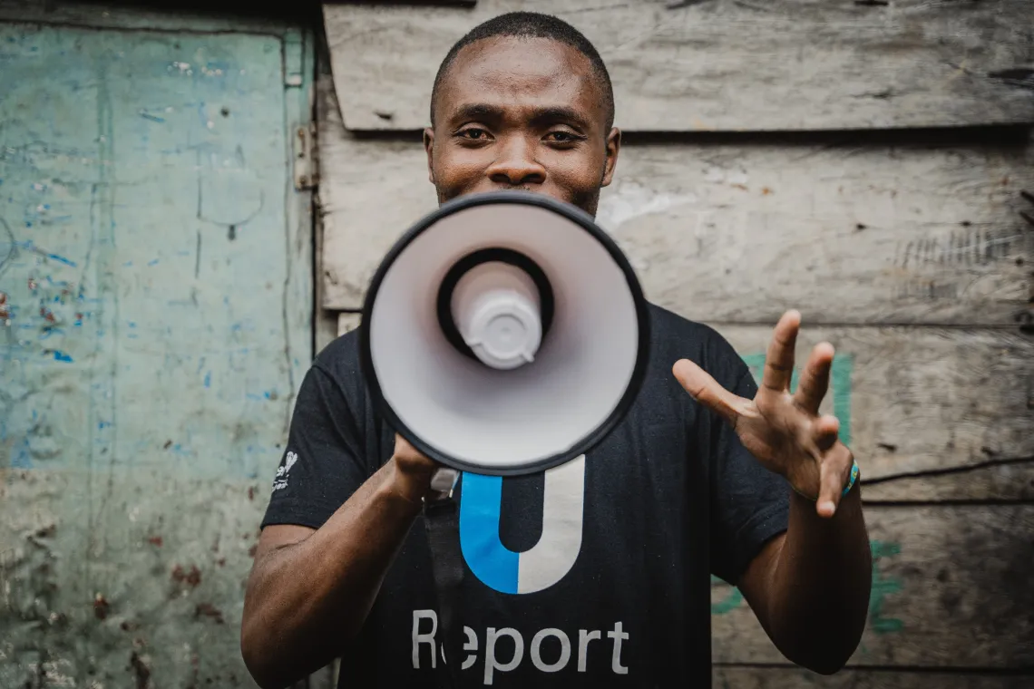 A young man holding a megaphone