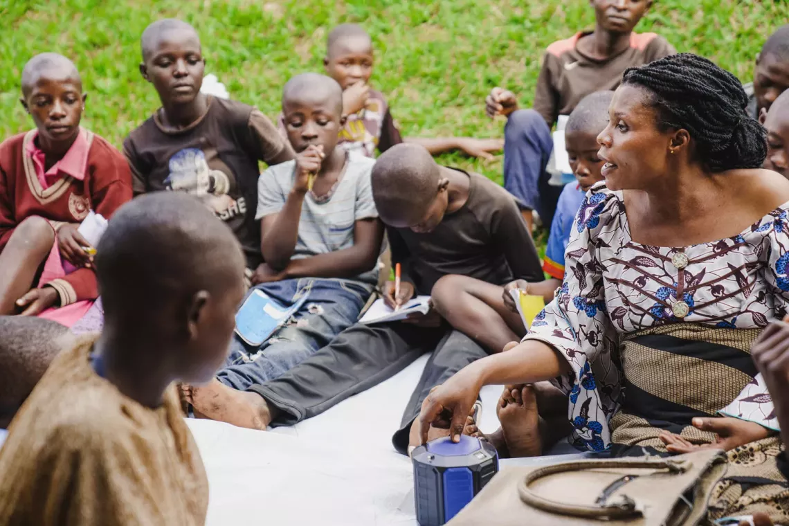 Grace Lenjika, a level three teacher at the circle group, teaches young schoolchildren via radio in Minova in South Kivu