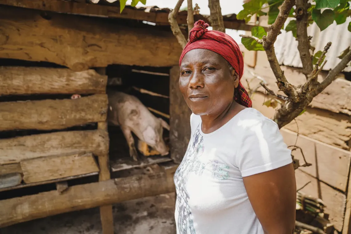 A women standing next to a pig