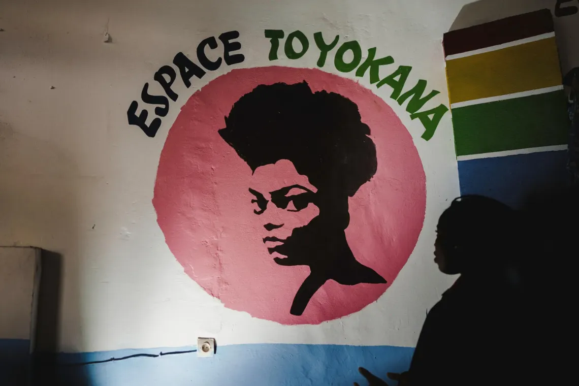 DRC. looks at the logo of the Toyokana safe space supported by UNICEF.