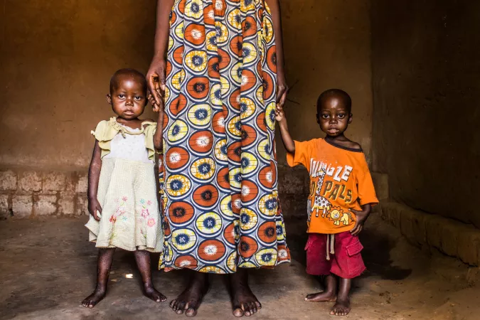 Une m&egrave;re tenant ses deux enfants malnutris