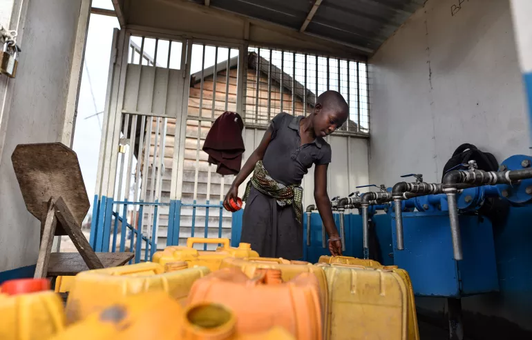 Une femme qui puise de l'eau &agrave; Goma