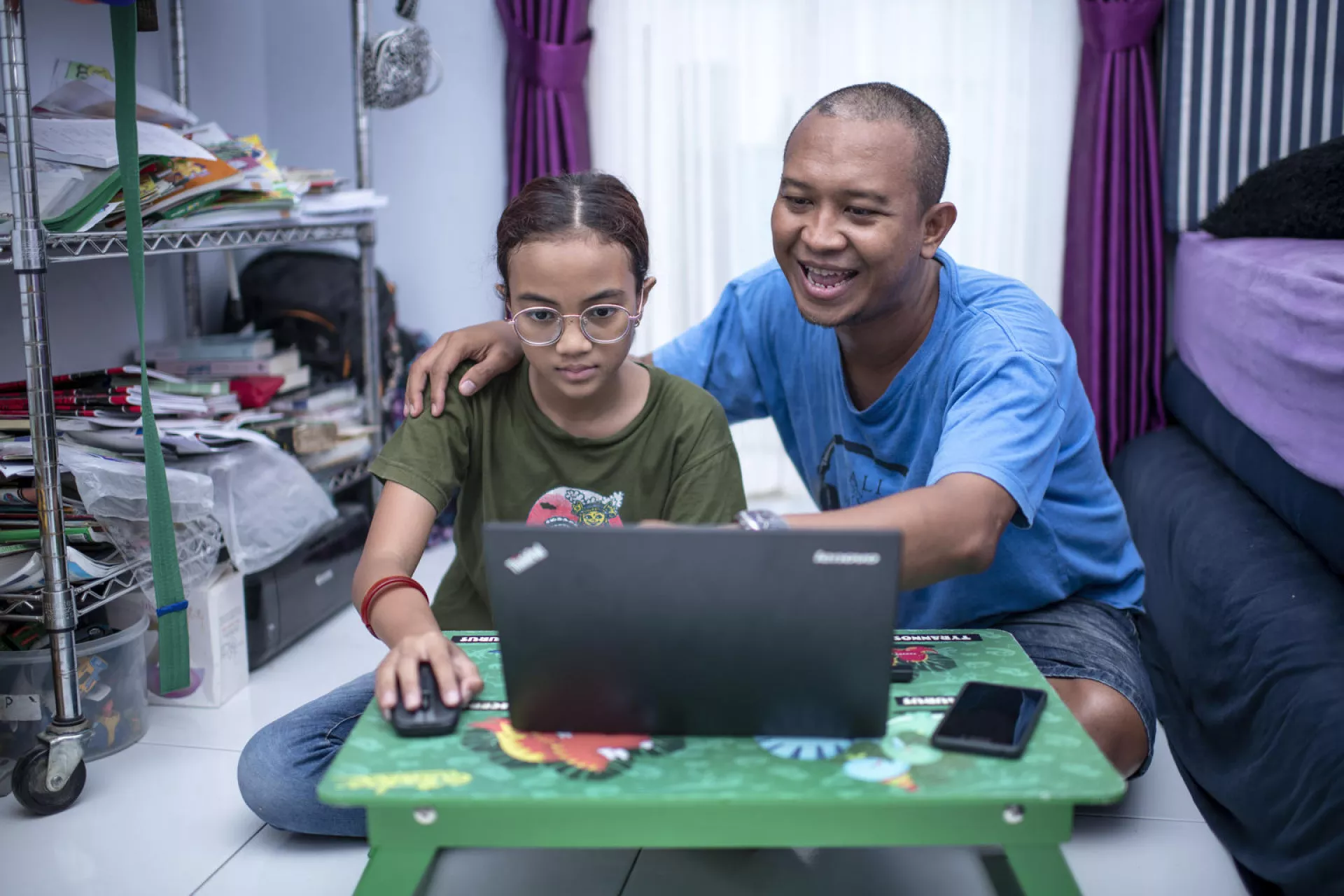 Equita Anemona, 10, studies online at home with her father Arseno in Bekasi, Indonesia