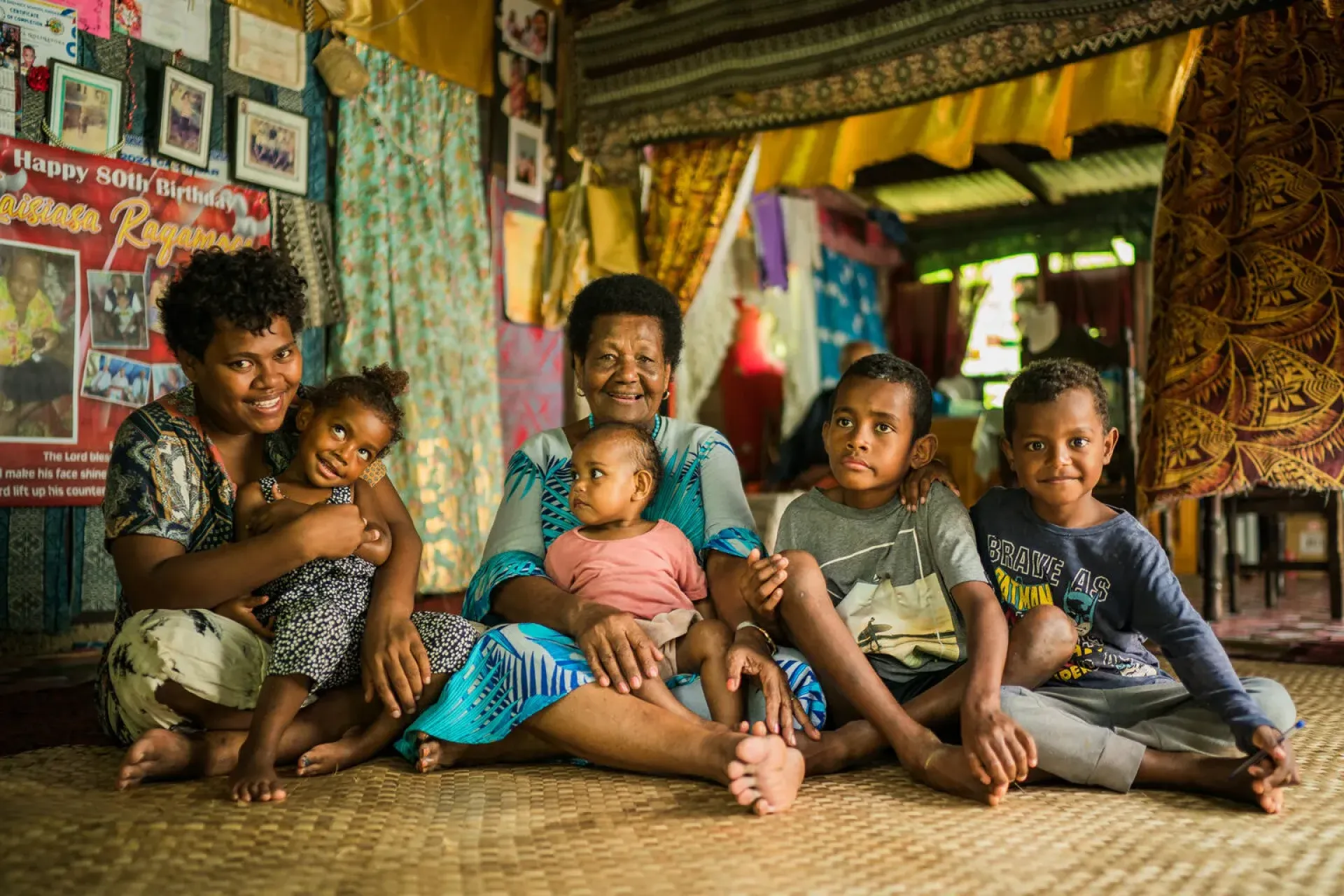 Lowata Matanisiga with one of her daughters, and four of her grandchildren in their home in the village of Cautata in Central, Fiji.