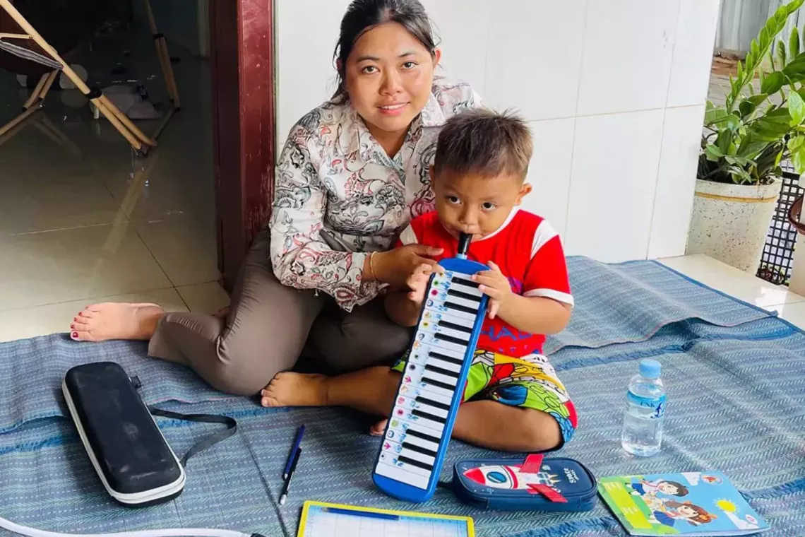 A mother and her son playing melodeon 