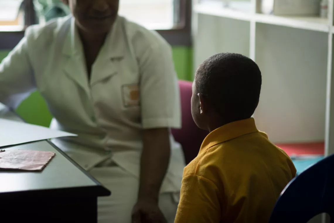 A health worker providing counselling to a child victim of sexual abuse