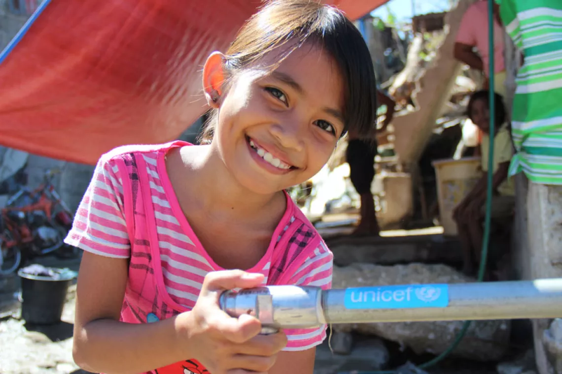 A girl buy a unicef-supported tap in the Philippines
