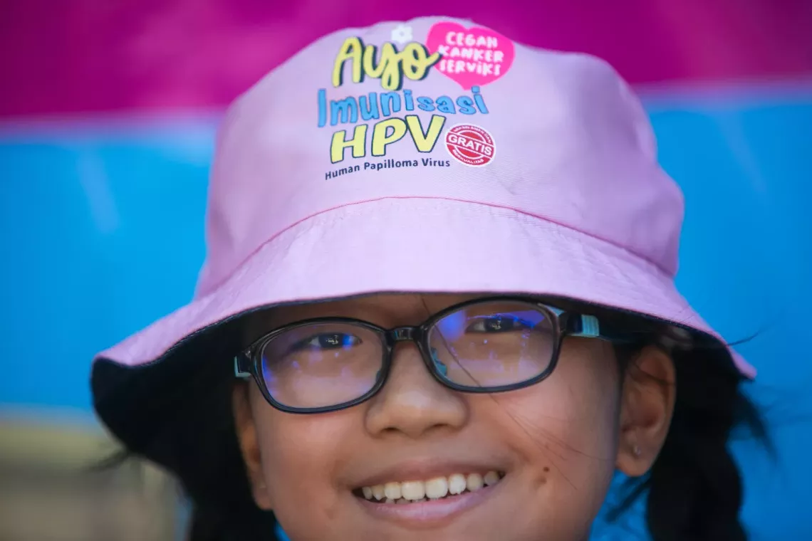 A student wearing hat during an event for the nationwide scale-up of Human Papilloma Virus (HPV) immunization, in Indonesia