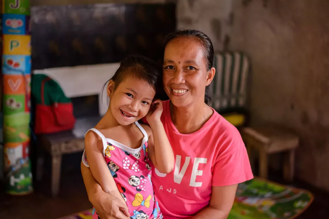 A woman and her child inside their home in Camaligan, Camarines Sur