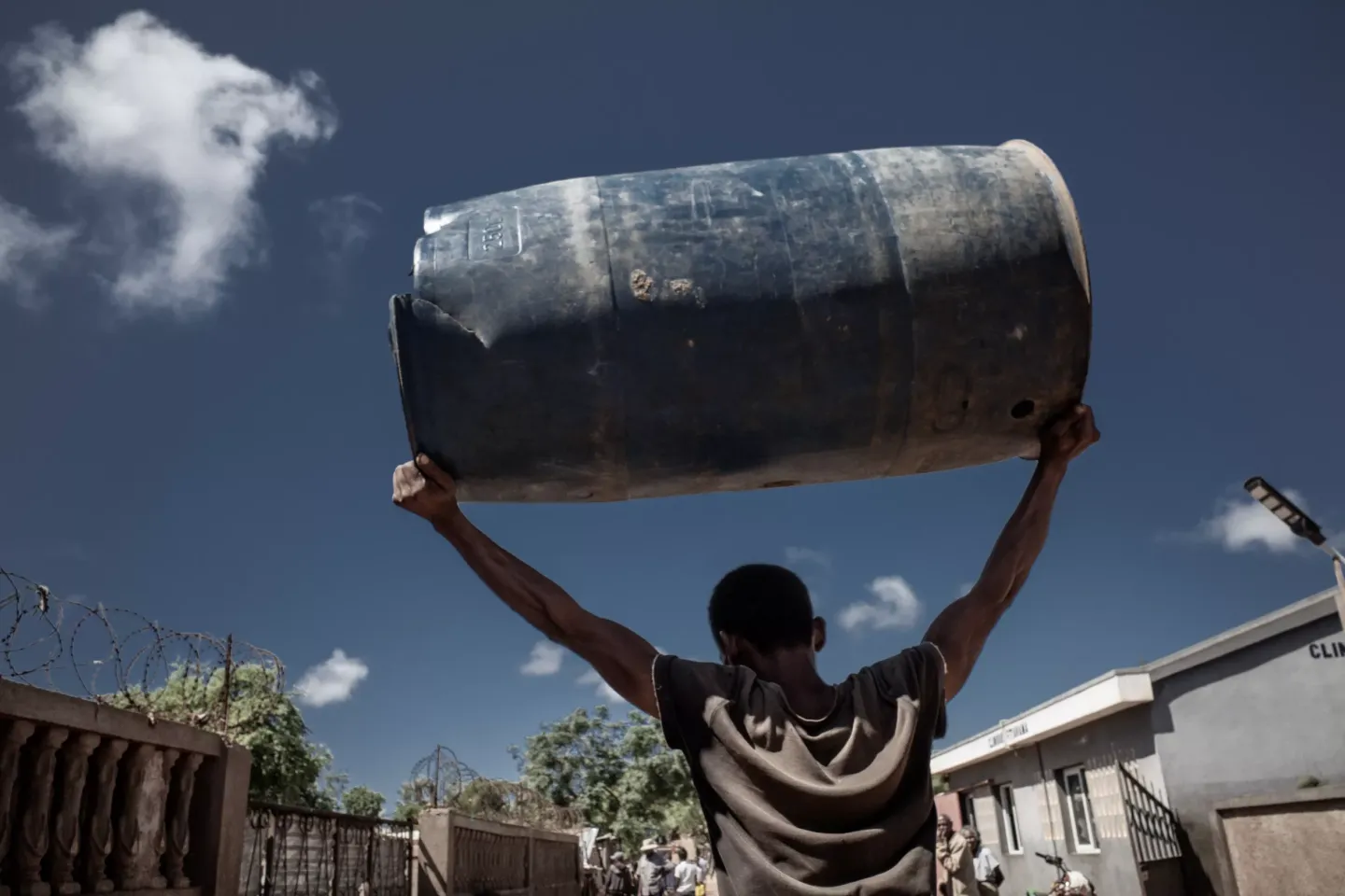 CHILD Walking with barrel of water