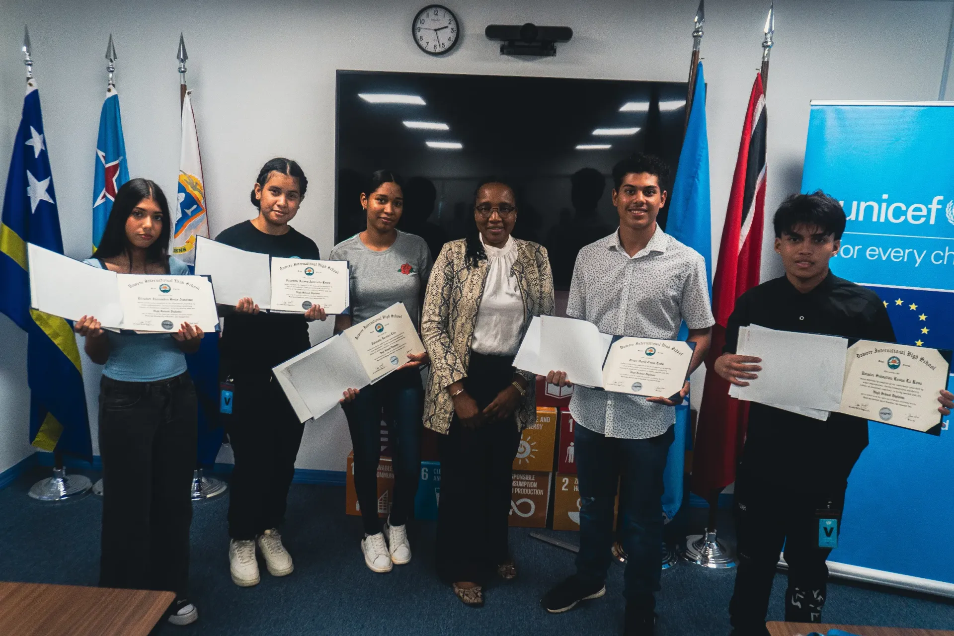 Students showing there high school diplomas