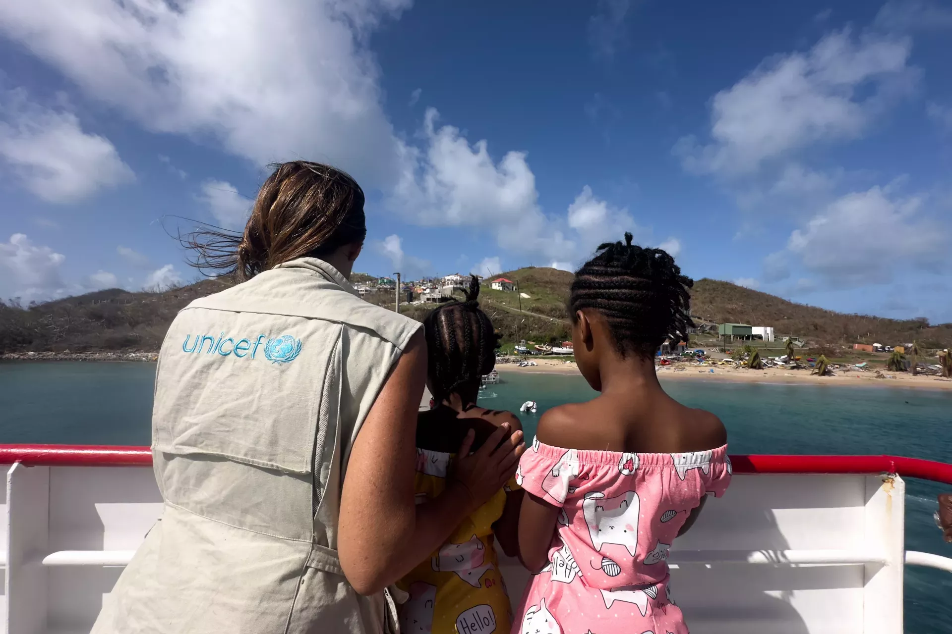 St vincent and the grenadines unicef official with two girls
