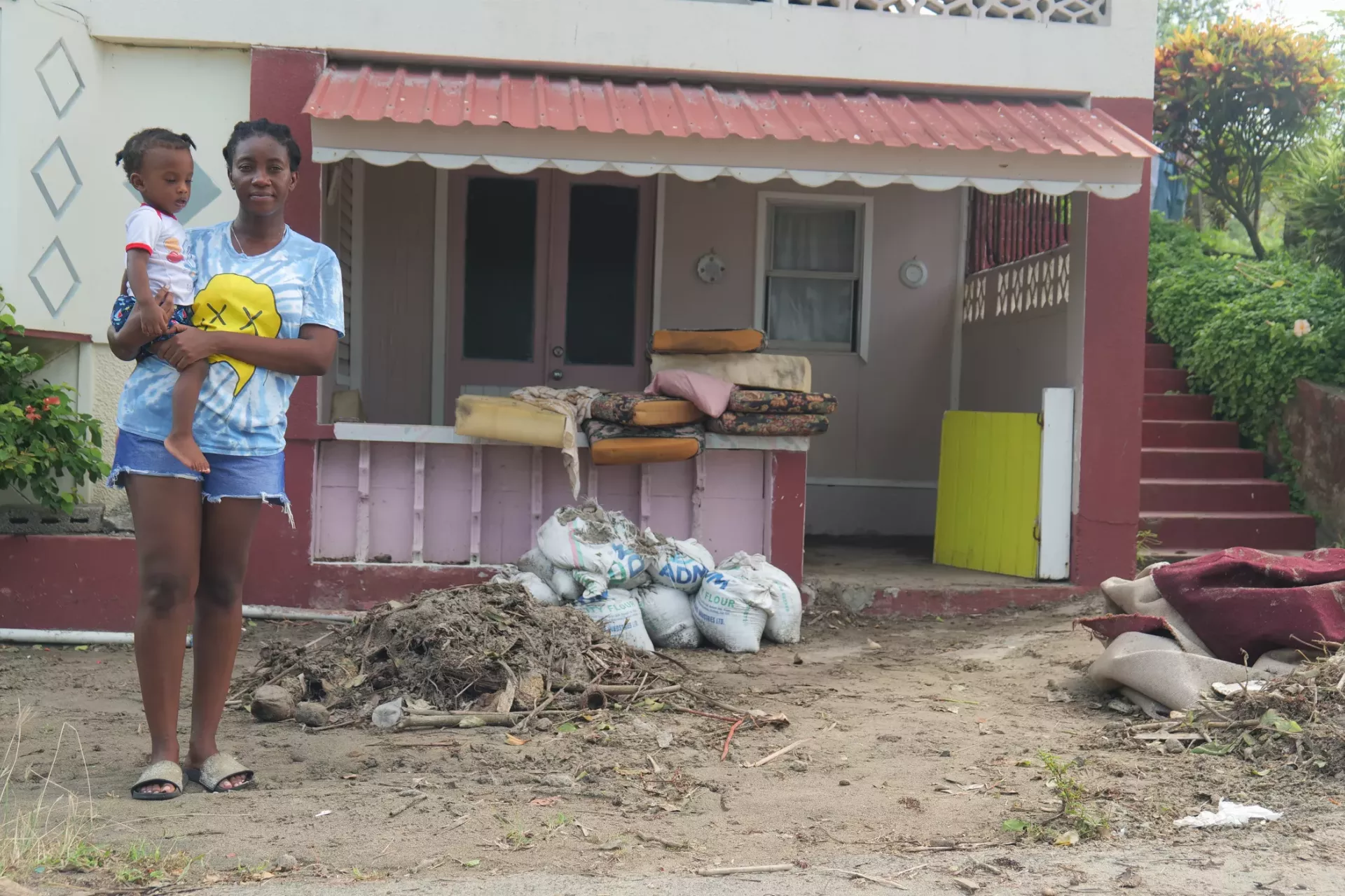 Mother and child in the aftermath of Hurricane Beryl in Grenada