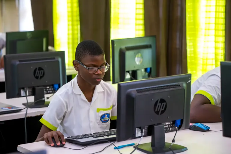 Child in front of computer screen in Antigua