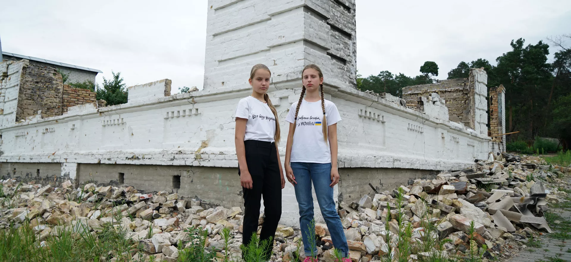 Ukrainian girl in front of their destroyed school.