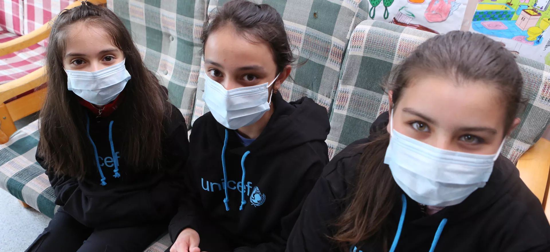 Marianna, Marina Khachatryan's eldest daughter, Manana, 8, Knara Mirzoyan's daughter, and their friend just tried on hoodies provided by UNICEF Armenia to children of their shelter in Tsaghkdzor.