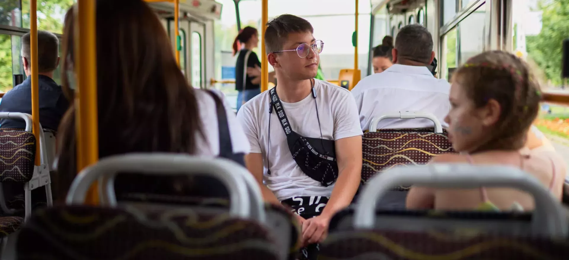 A boy sits on a bus.