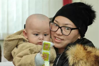 A mother and her child examine a pack of gulazyk (vitamins) in rural Kyrgyzstan on 24 March 2018. As part of a Ministry of Health programme, UNICEF together with other partners provides children with these vitamins and minerals to reduce iron-deficiency anaemia among babies. 