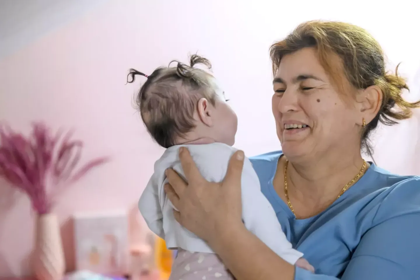 Foster mother holds child.