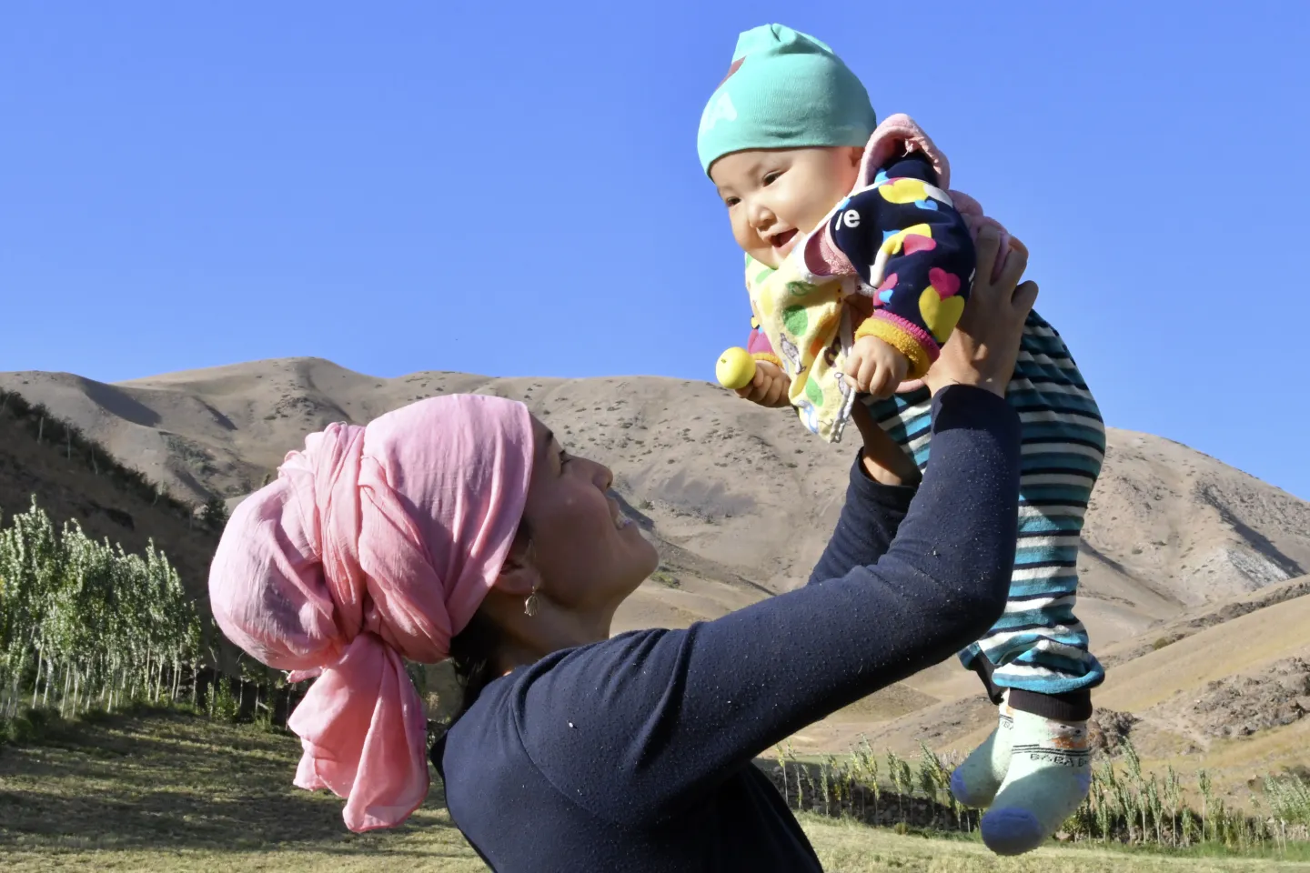 Mother holds her baby in Osh, Kyrgyzstan.
