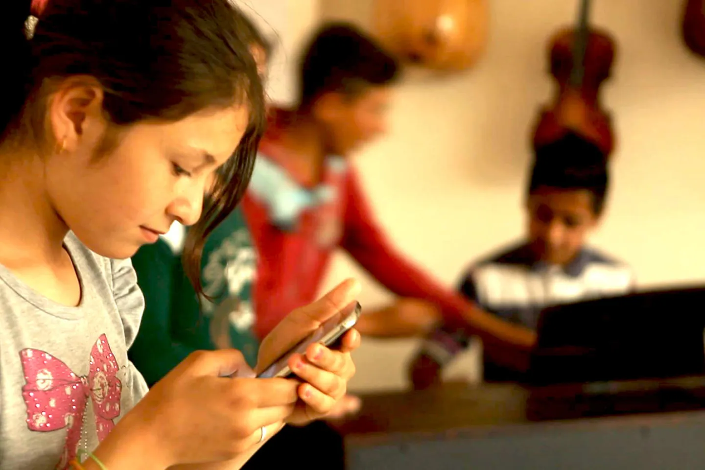 The girl is looking at her smartphone