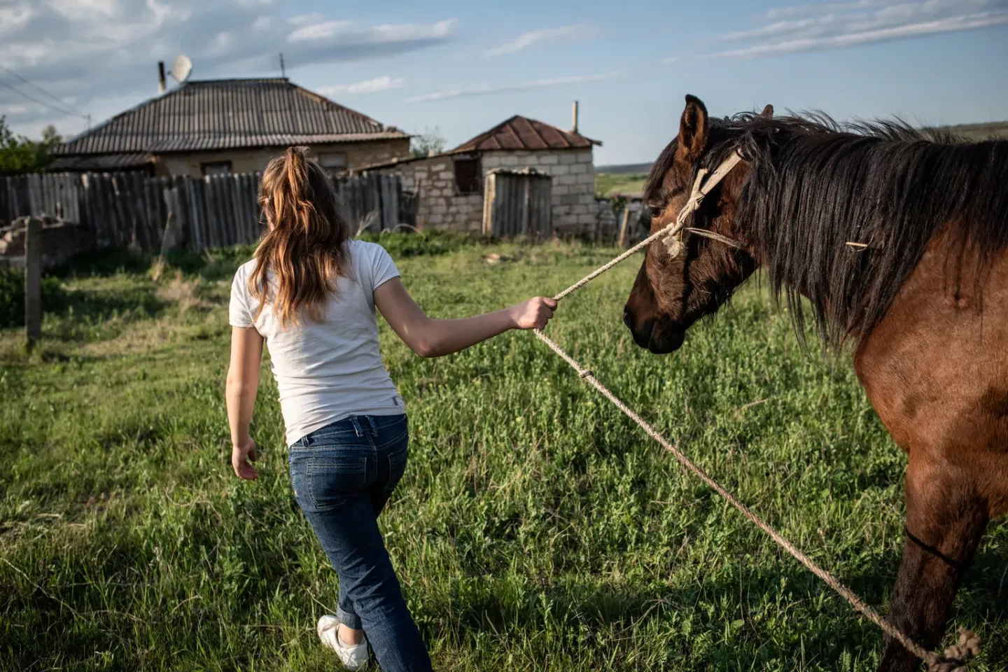 Twelve-year-old Liza walks her family&rsquo;s horse to her house in her village in Moldova. After being sexually abused by her stepfather,  Liza was helped by a UNICEF-supported shelter in Chisinau, where she received medical, social and psychological support. April 2018