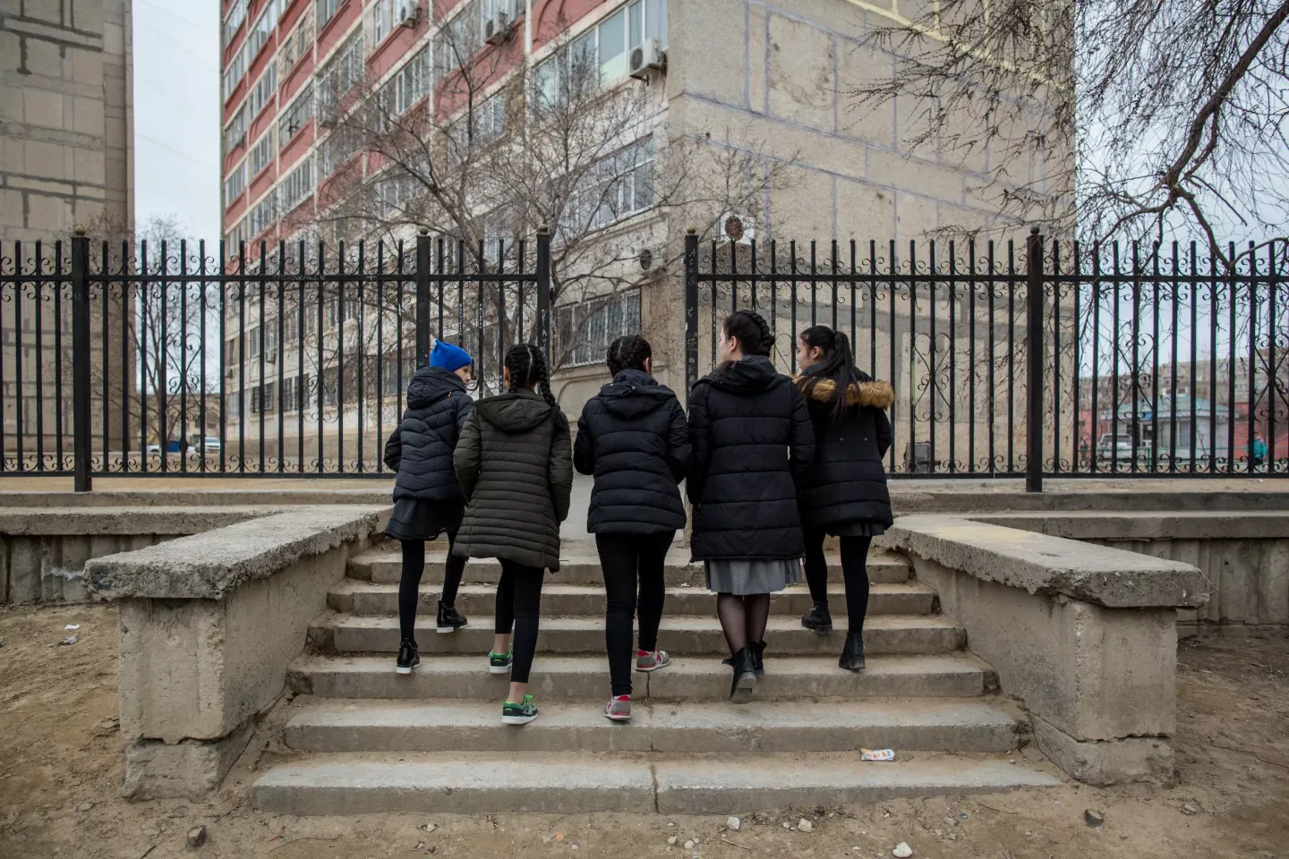 Aliya, 13, walks with her classmates in Aktau, Kazakhstan.  Aliya is a survivor of domestic violence and receives support  from a UNICEF-backed crisis centre to help her and her  siblings overcome their distress and trauma. March 2018. 