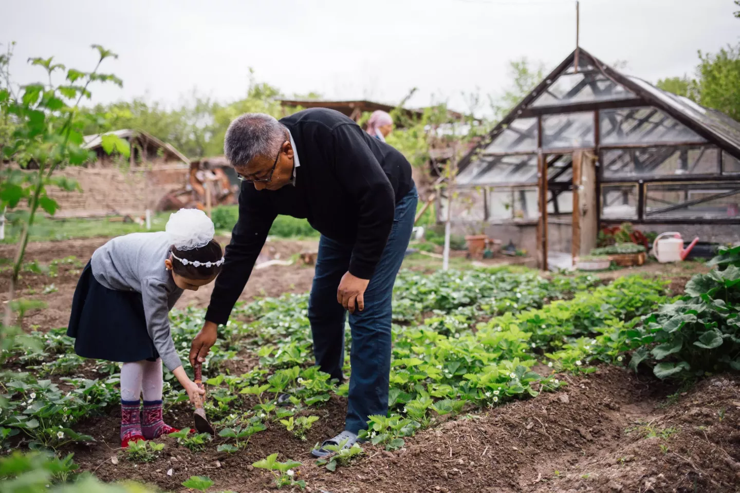 A schoolgirl tends to a garden in rural Kyrgyzstan, April 2010. For a sustainable future, green skills must be incorporated into every career training and class subject, from farming to architecture. 