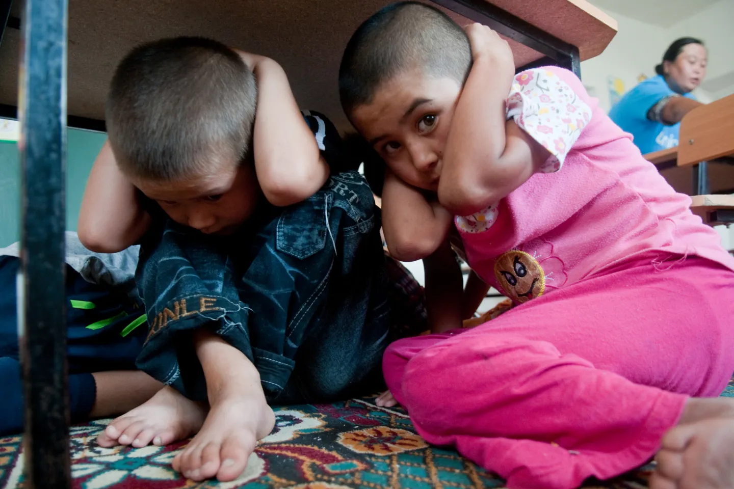 Children at a kindergarten in Kyrgyzstan take part in a drill to learn about safety in an emergency situation.
