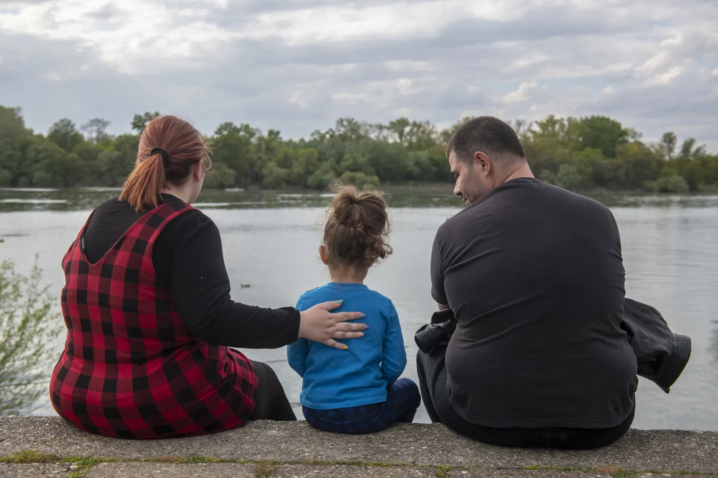 A family looks out over the water. 