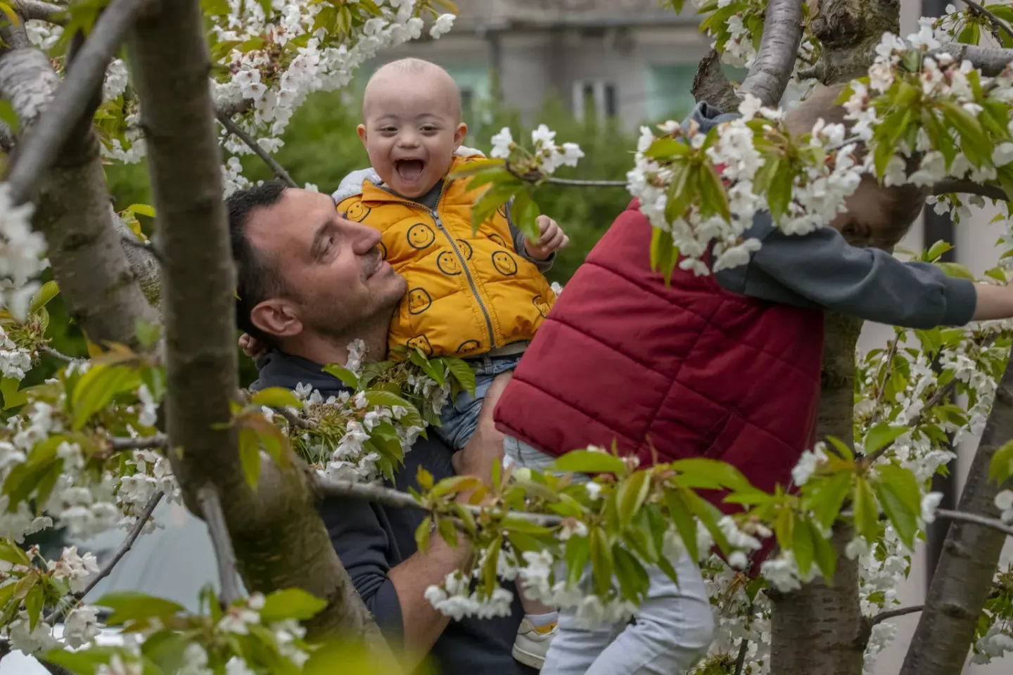 Andrija Radosavljevic (aged three) and Mateja Radosavljevic play with their father Milan Radosavljevic. Serbia. April 2022.