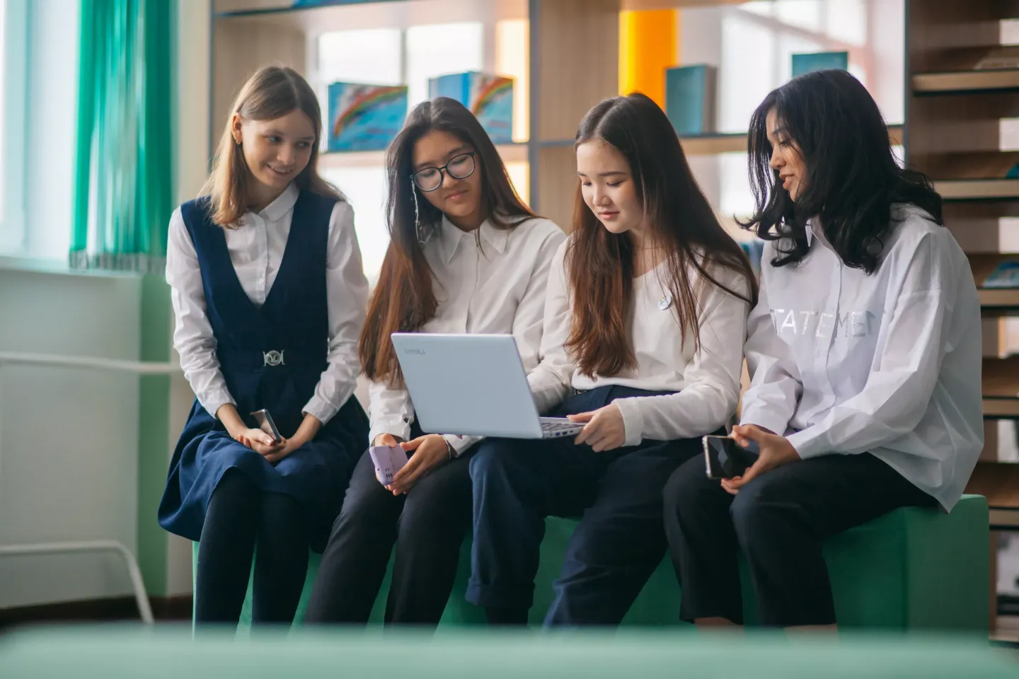 Victoria, Diana, Sanel and Deniz watch educational videos in the library  of&nbsp;the gymnasium School No. 91 in Nur-Sultan, Kazakhstan. February 2022