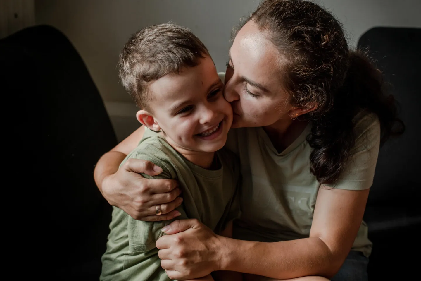 6-year-old Mykyta (left) spends time with his mother, Kateryna, in their apartment near the center of the city