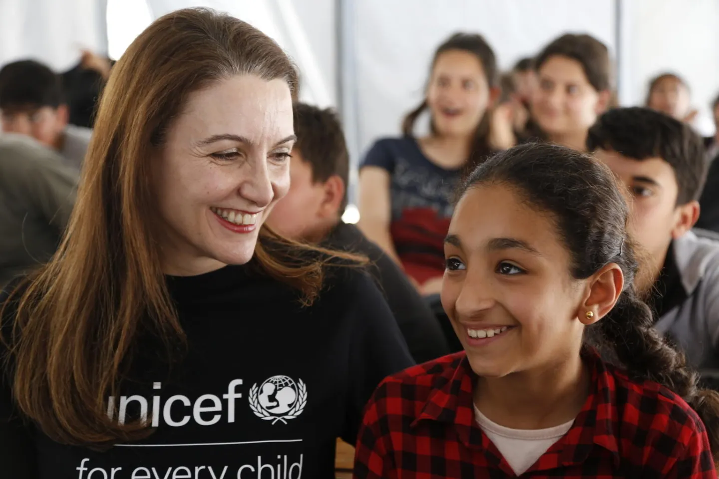 Regina De Dominicis, together with students in a UNICEF-supported tent classroom in Turkiye